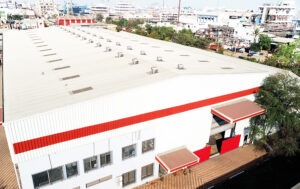Chemiplant factory: industrial building with red roof and white walls, symbolizing manufacturing and production