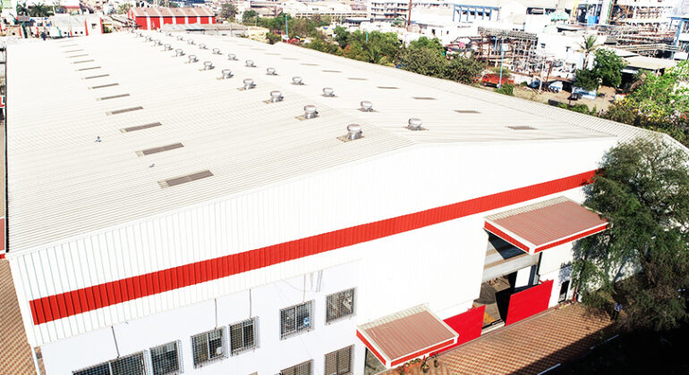 Chemiplant factory: industrial building with red roof and white walls, symbolizing manufacturing and production